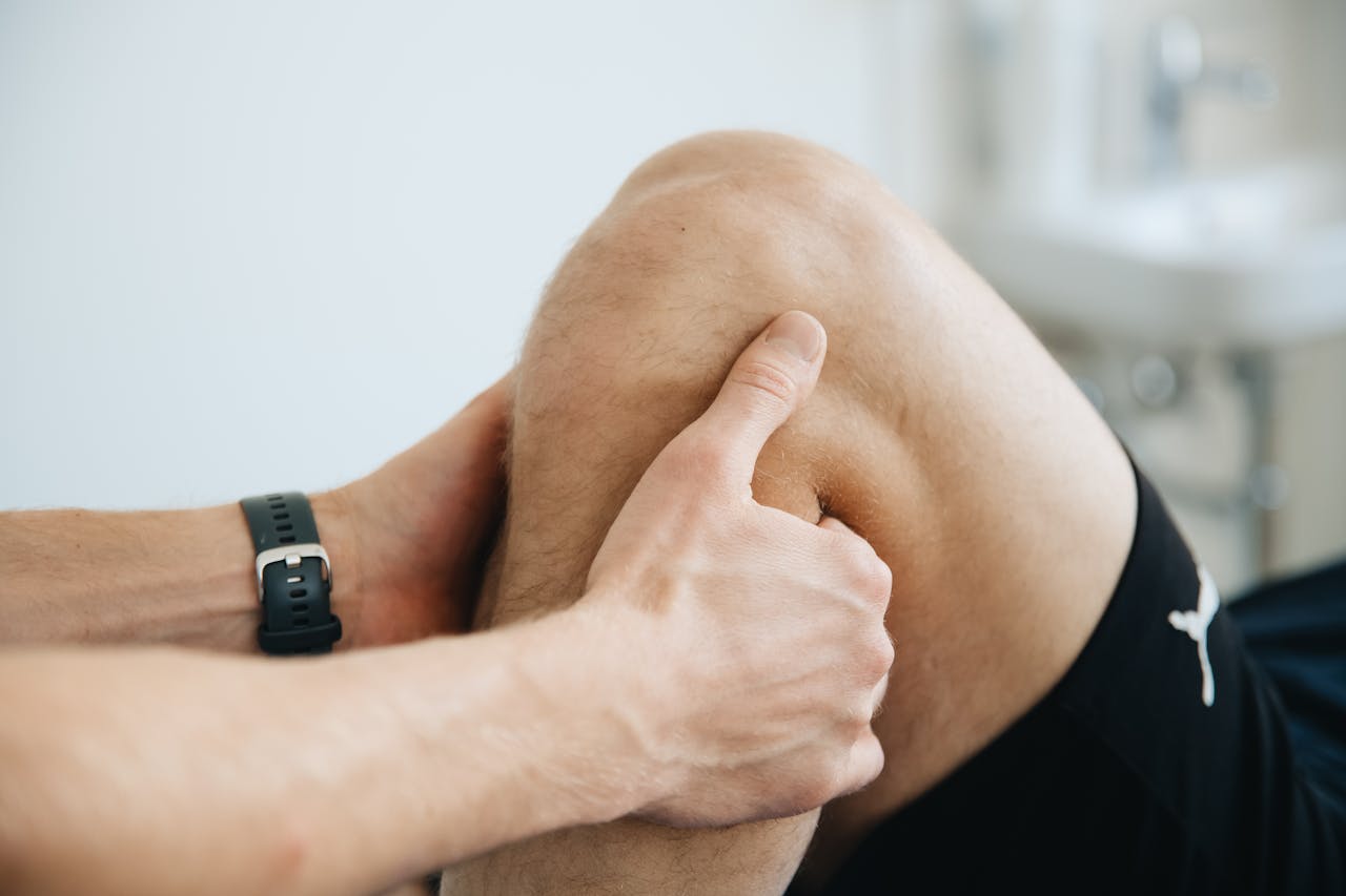Physiotherapist Massaging Knee and Leg